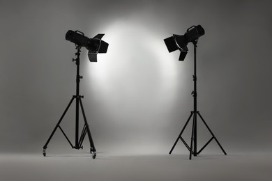 Grey photo background and professional lighting equipment in studio