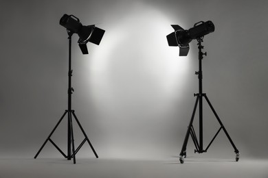 Photo of Grey photo background and professional lighting equipment in studio