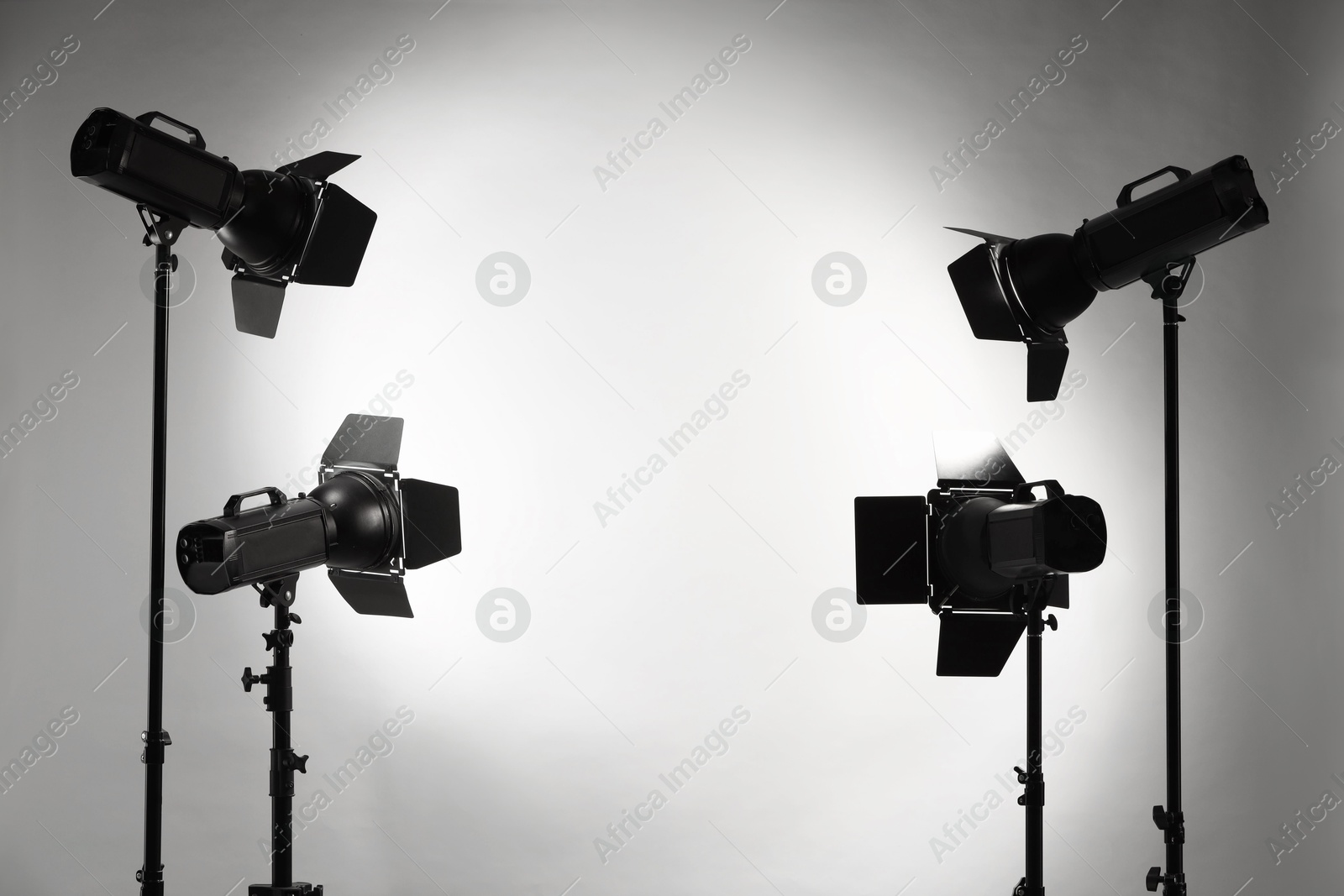 Photo of Grey photo background and professional lighting equipment in studio