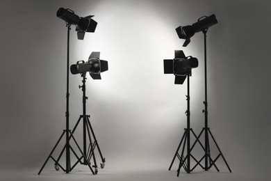 Grey photo background and professional lighting equipment in studio