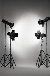 Grey photo background and professional lighting equipment in studio