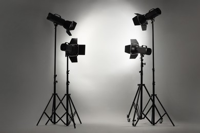 Photo of Grey photo background and professional lighting equipment in studio