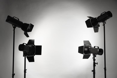 Photo of Grey photo background and professional lighting equipment in studio