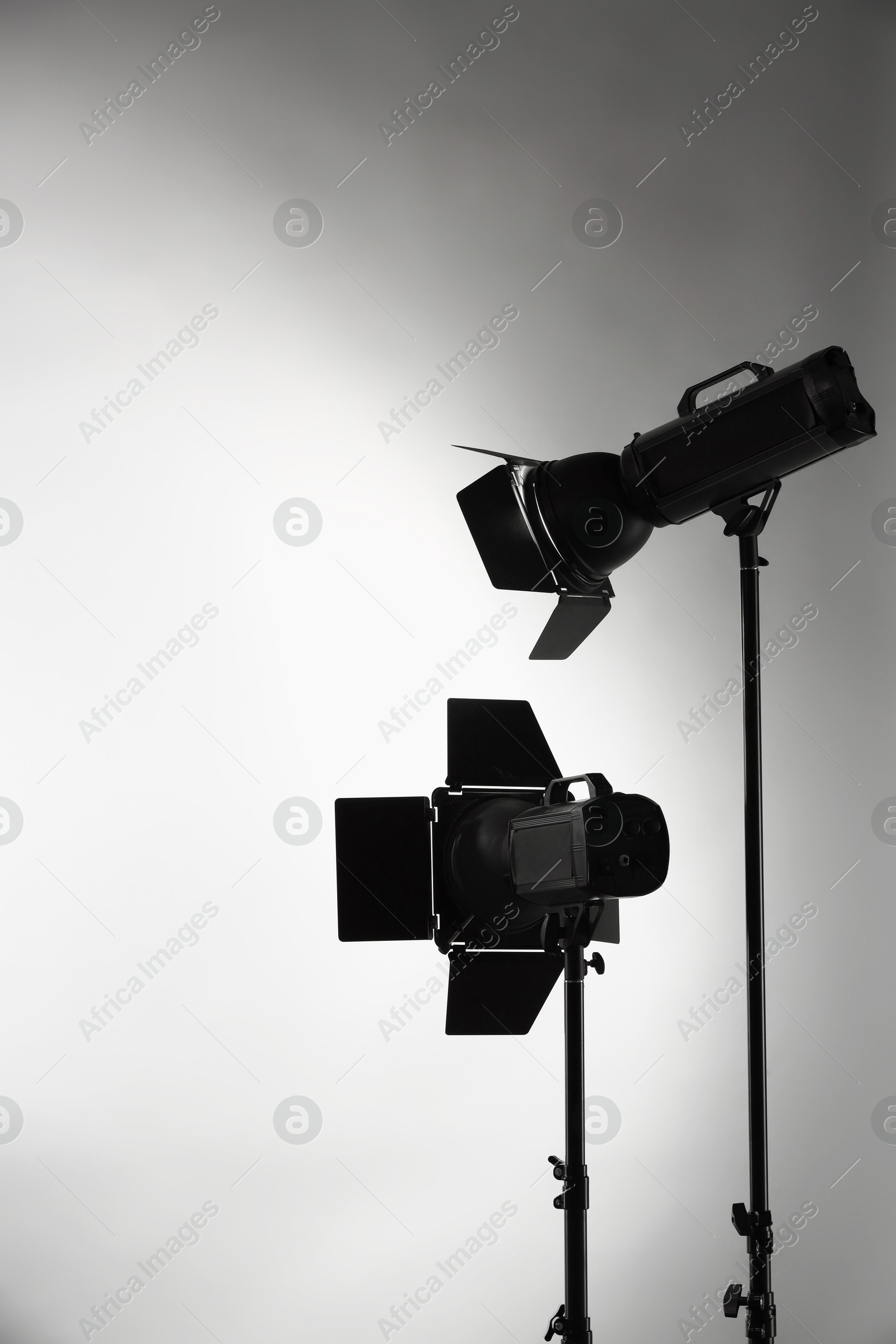 Photo of Grey photo background and professional lighting equipment in studio