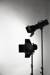 Grey photo background and professional lighting equipment in studio