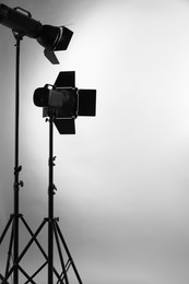 Photo of Grey photo background and professional lighting equipment in studio