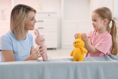 Photo of Puppet theatre. Mother and daughter performing show at home