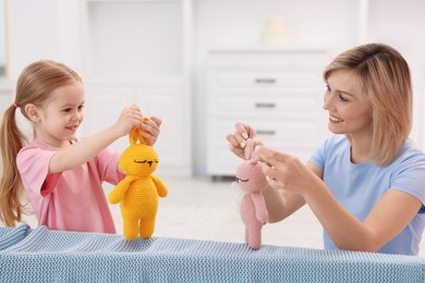 Photo of Puppet theatre. Mother and daughter performing show at home