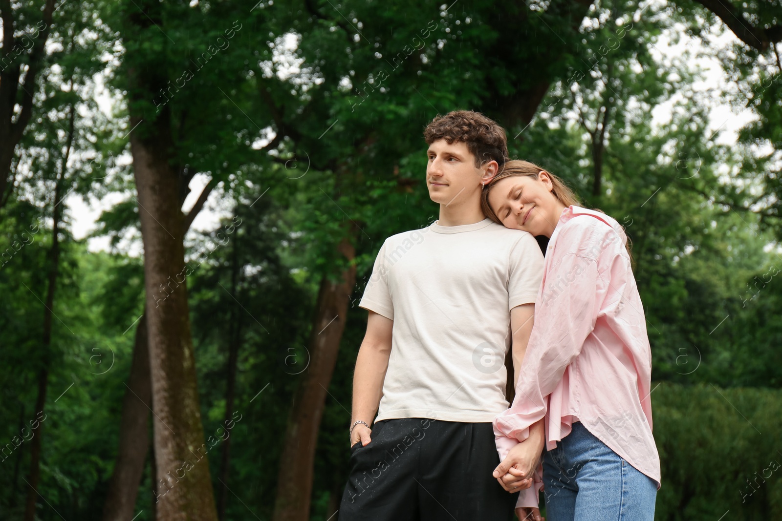 Photo of International dating. Lovely young couple spending time together in park, space for text