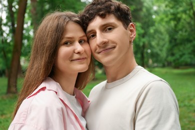 Photo of International dating. Lovely young couple spending time together in park