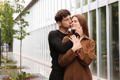 Photo of International dating. Lovely young couple spending time together outdoors, space for text