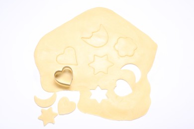 Photo of Raw dough and cookie cutter isolated on white, top view