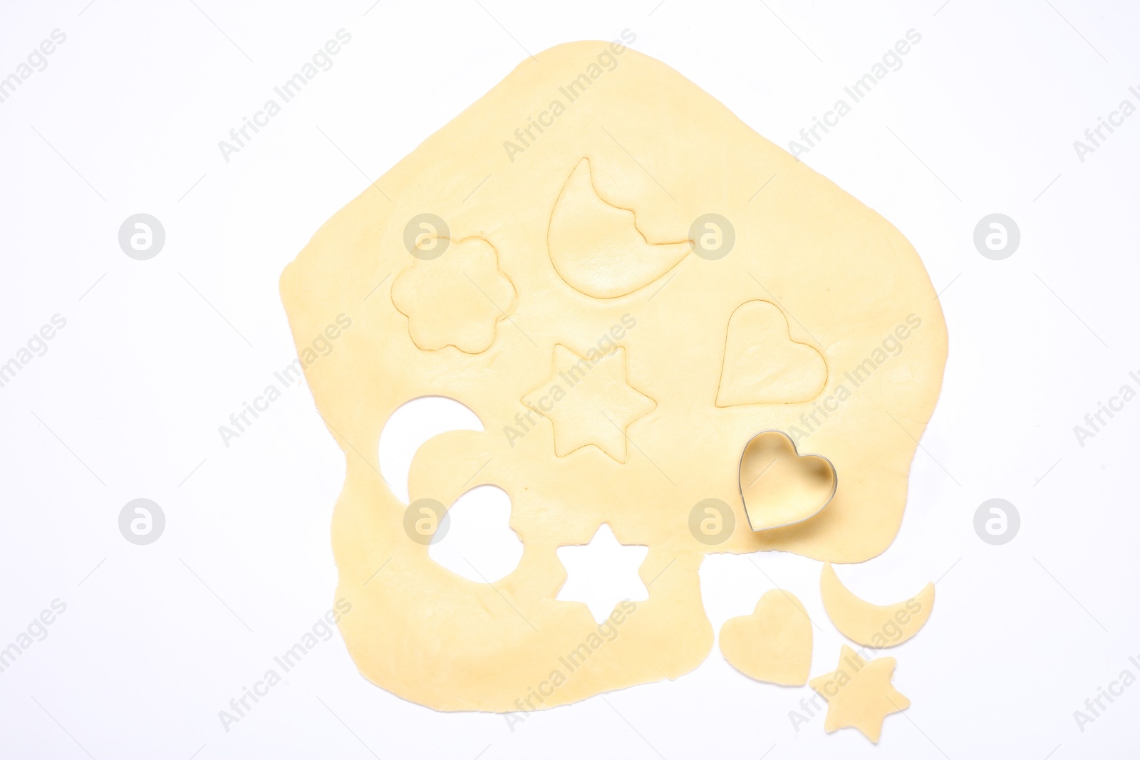 Photo of Raw dough and cookie cutter isolated on white, top view