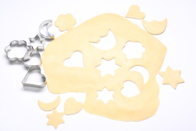 Raw dough and cookie cutters isolated on white