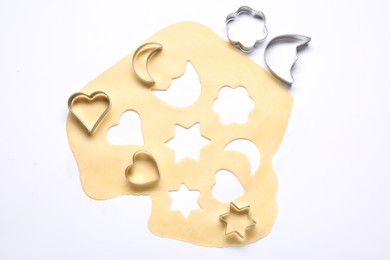 Raw dough and cookie cutters isolated on white, top view