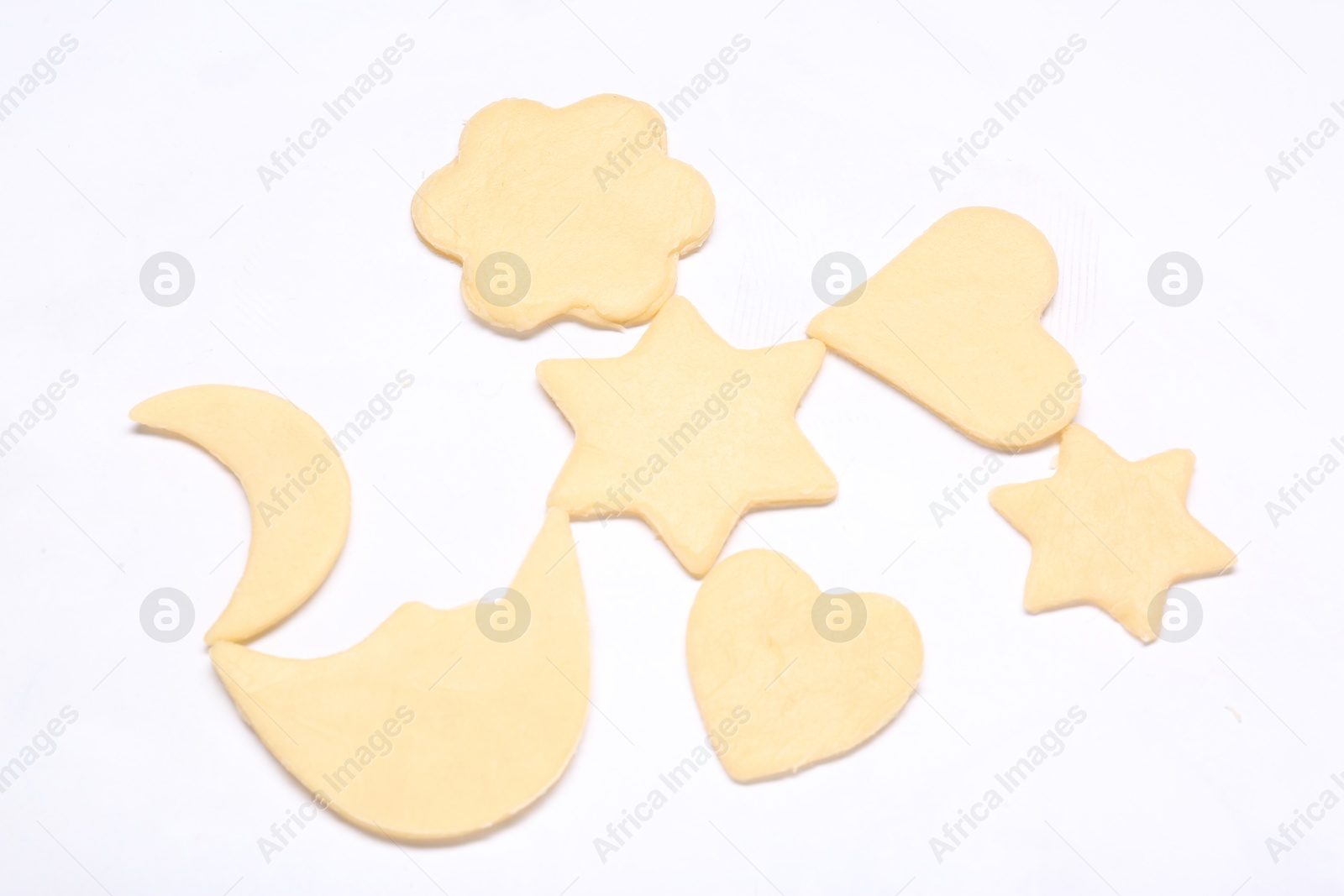 Photo of Raw cookies in different shapes isolated on white