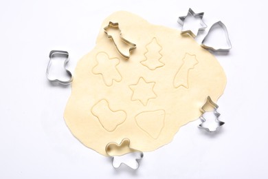 Raw dough and cookie cutters isolated on white, top view