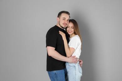 Photo of Happy couple hugging on grey background. Strong relationship