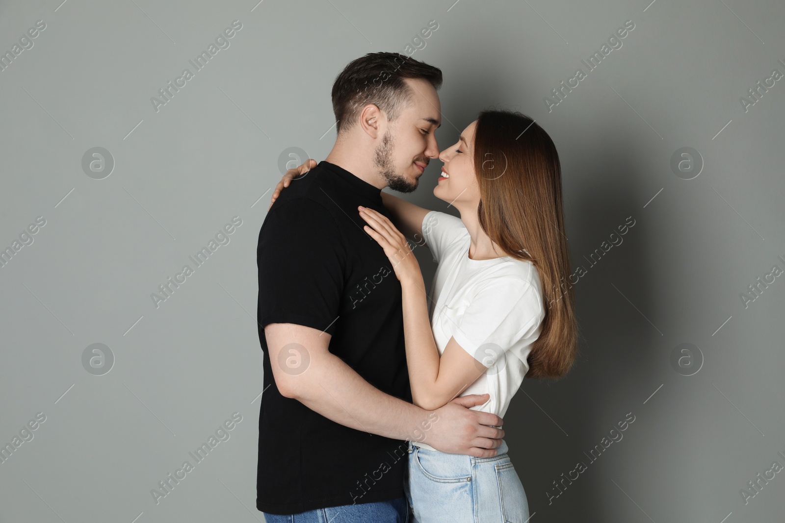 Photo of Cute couple hugging on grey background. Strong relationship
