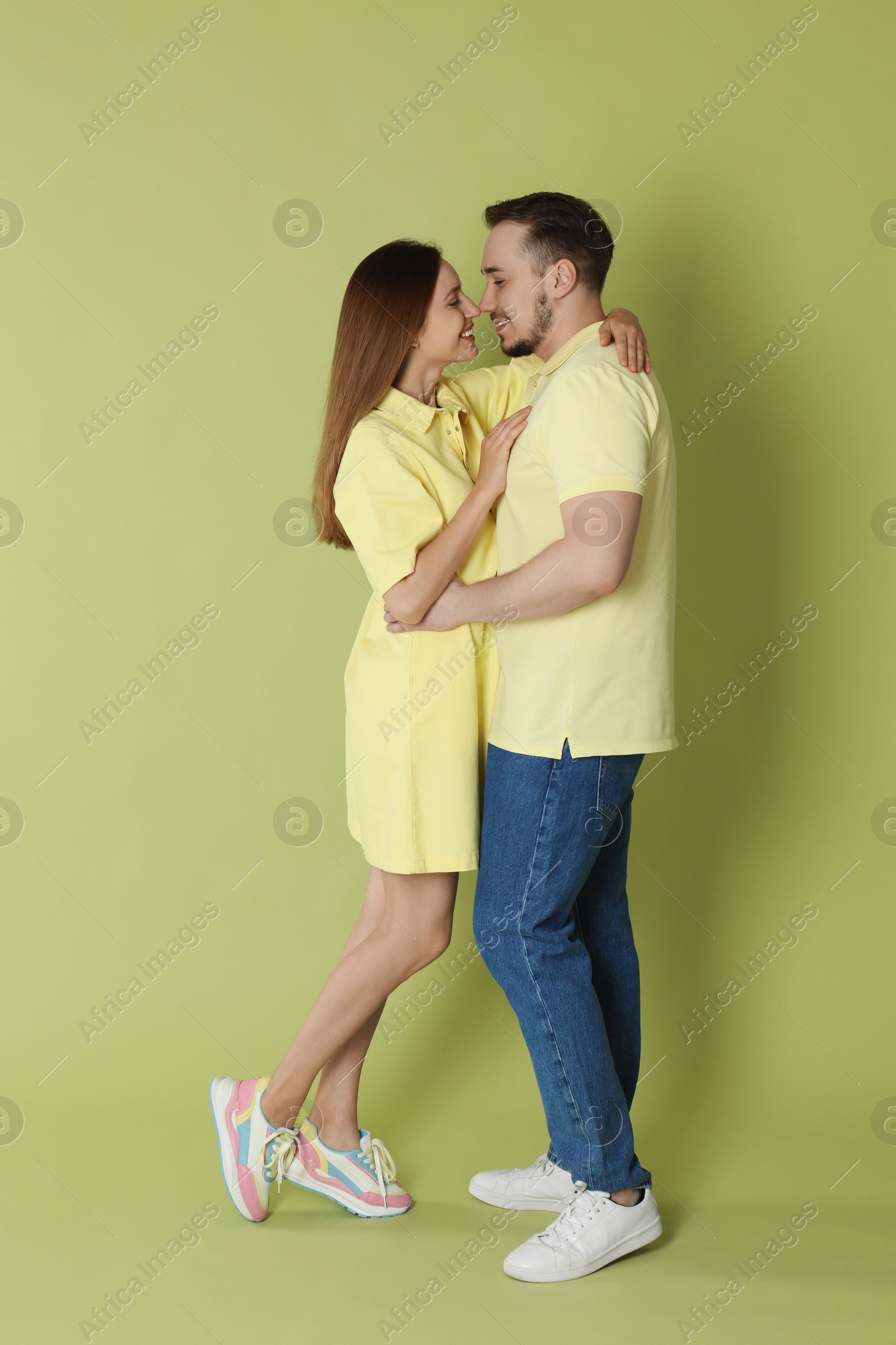 Photo of Happy couple hugging on green background. Strong relationship