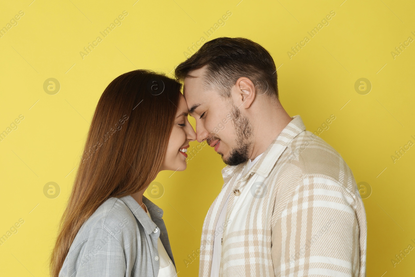 Photo of Happy couple on yellow background. Strong relationship