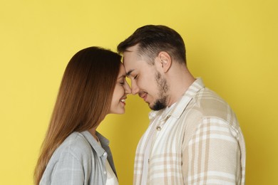 Happy couple on yellow background. Strong relationship