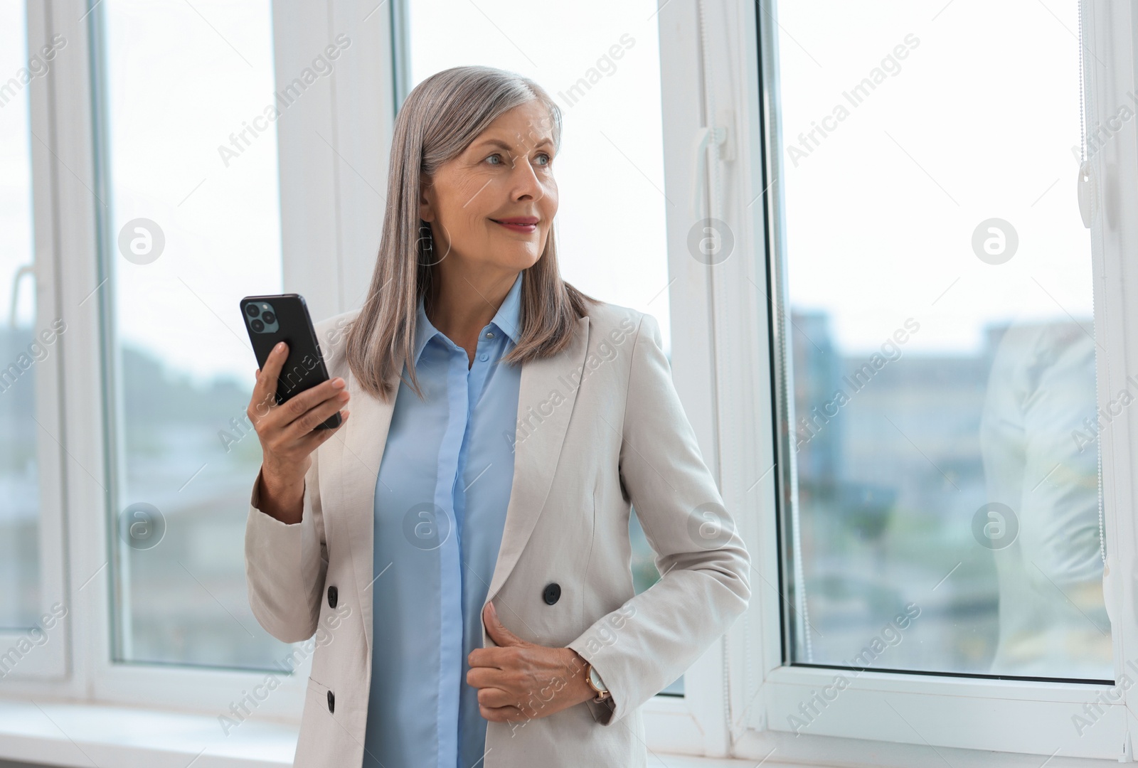 Photo of Senior woman using mobile phone at home, space for text