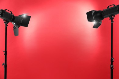 Red photo background and professional lighting equipment in studio