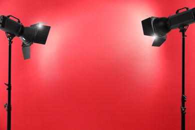 Photo of Red photo background and professional lighting equipment in studio