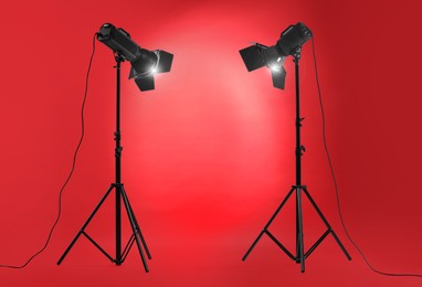 Photo of Red photo background and professional lighting equipment in studio