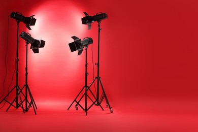 Red photo background and professional lighting equipment in studio