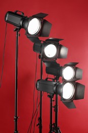 Photo of Red photo background and professional lighting equipment in studio