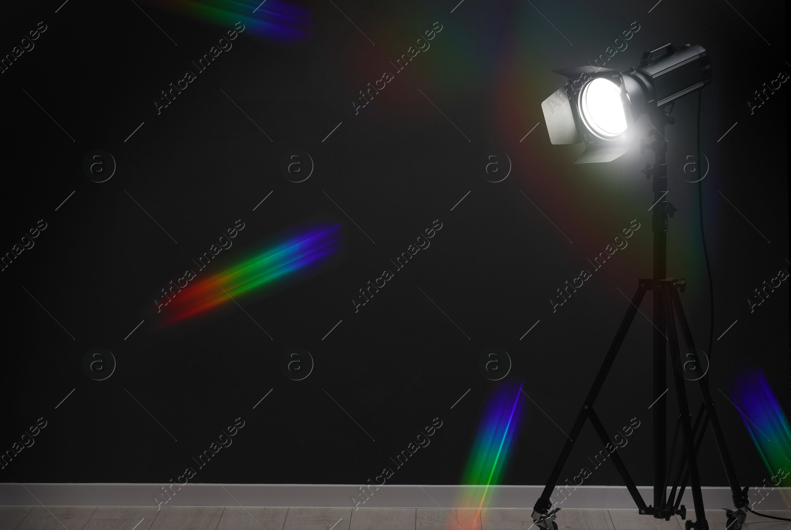 Photo of Dark photo background and professional lighting equipment in studio, space for text