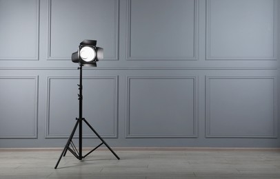 Photo of Professional lighting equipment in photo studio, space for text