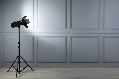 Photo of Professional lighting equipment in photo studio, space for text