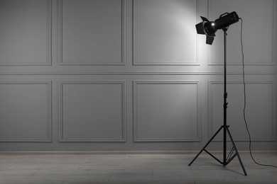 Photo of Professional lighting equipment in photo studio, space for text