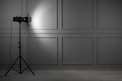 Photo of Professional lighting equipment in photo studio, space for text