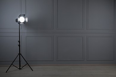 Photo of Professional lighting equipment in photo studio, space for text