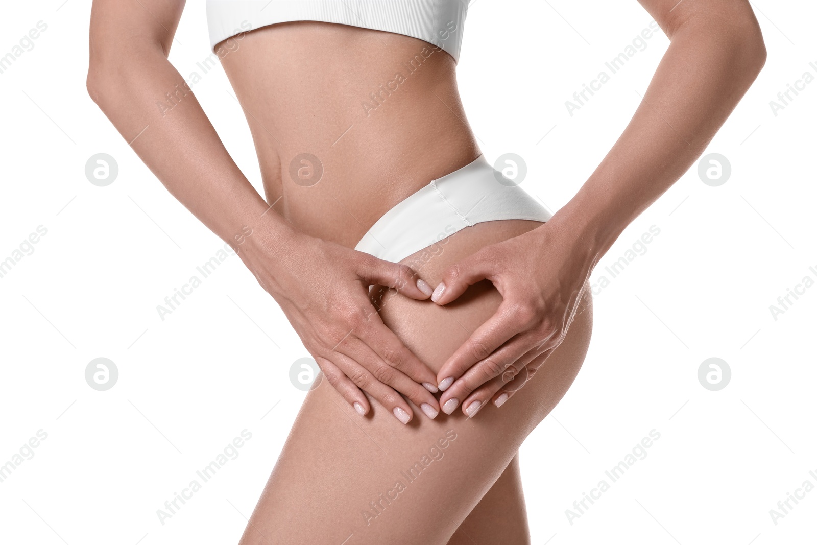 Photo of Woman in underwear making heart with hands near thigh on white background, closeup. Cellulite problem
