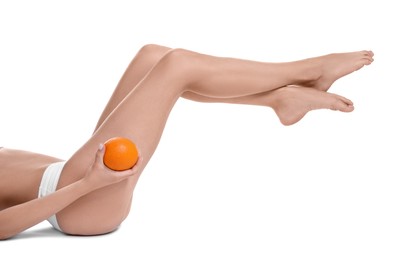 Photo of Woman in underwear with orange on white background, closeup. Cellulite problem