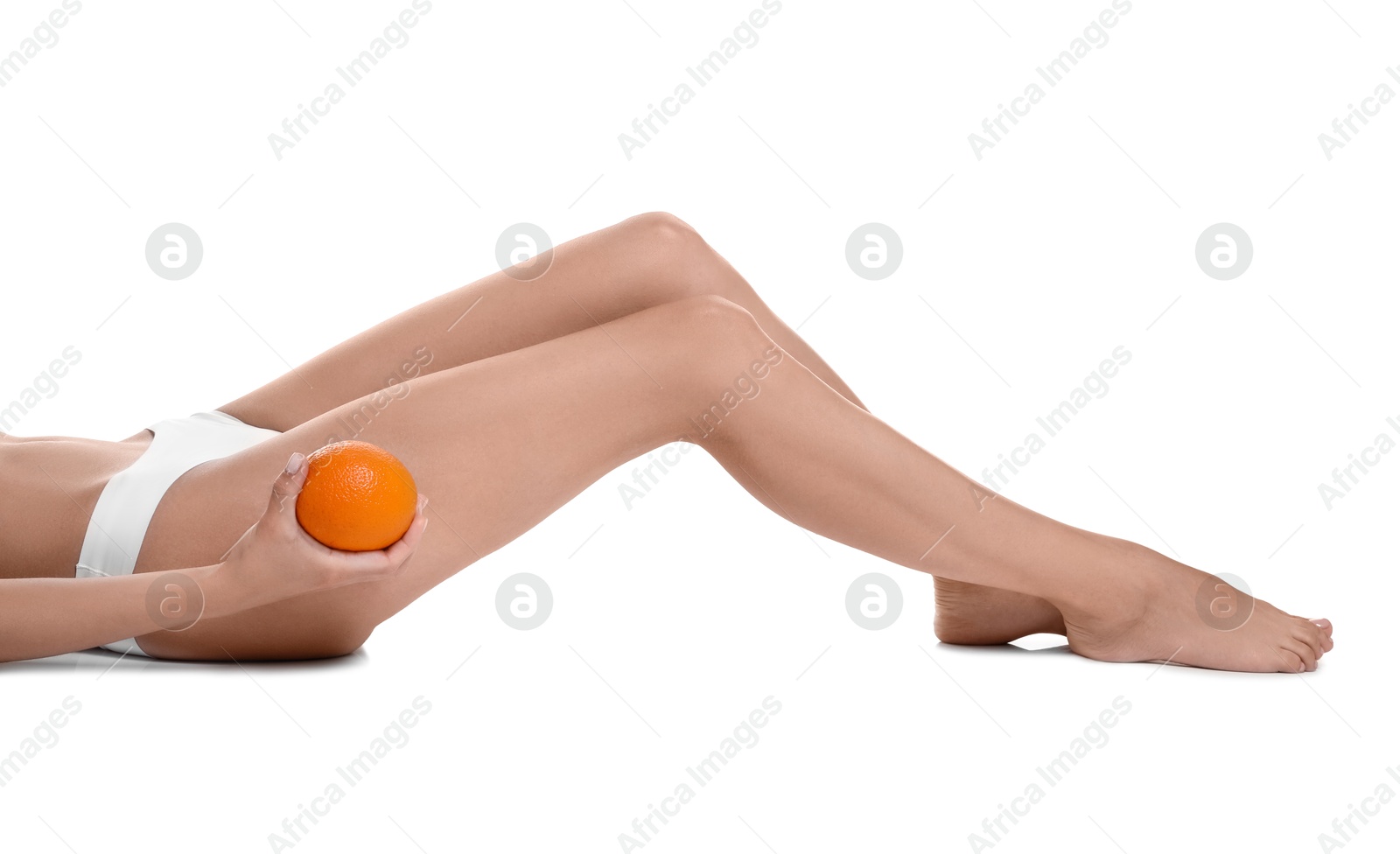 Photo of Woman in underwear with orange on white background, closeup. Cellulite problem