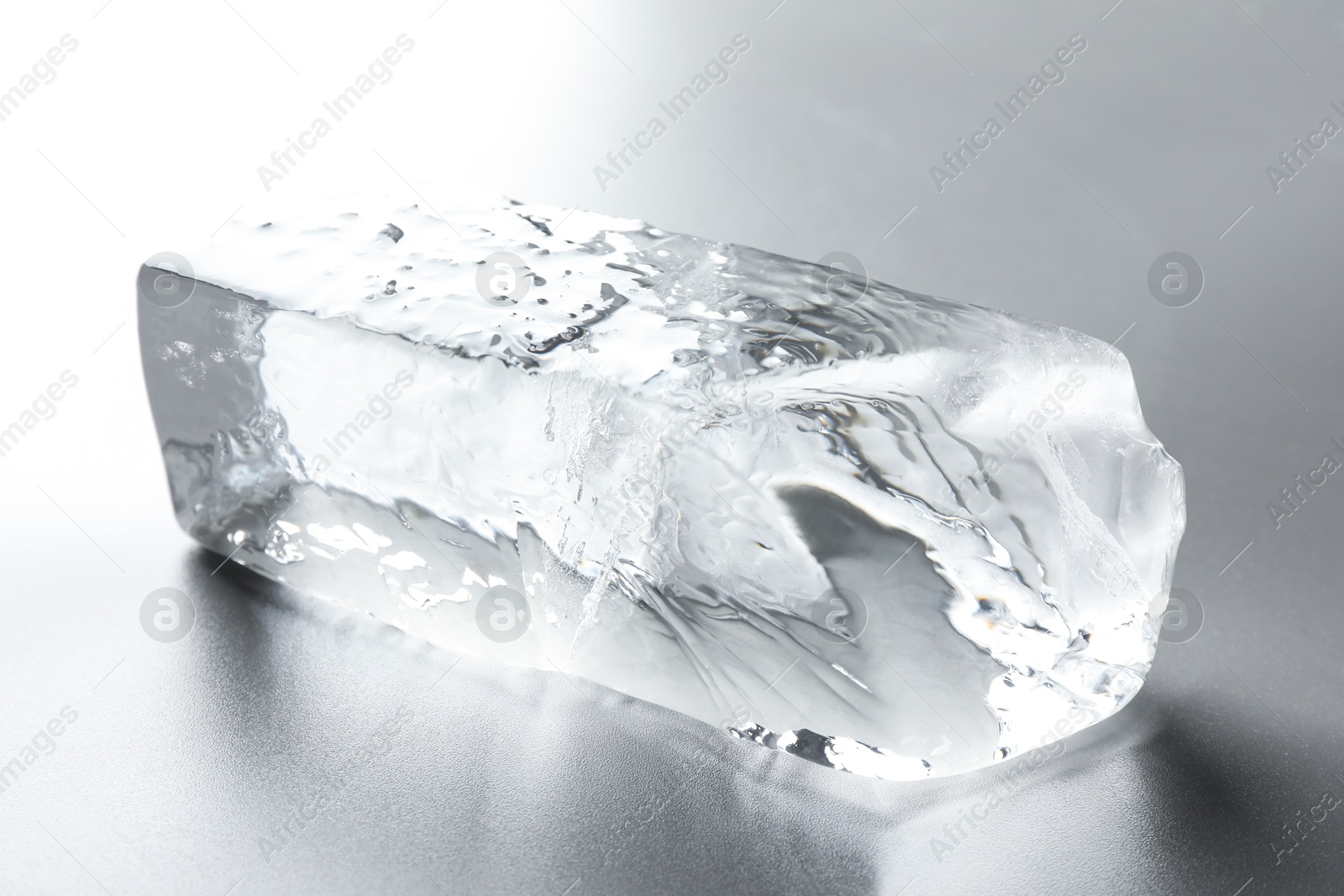 Photo of Piece of clear ice on light grey table