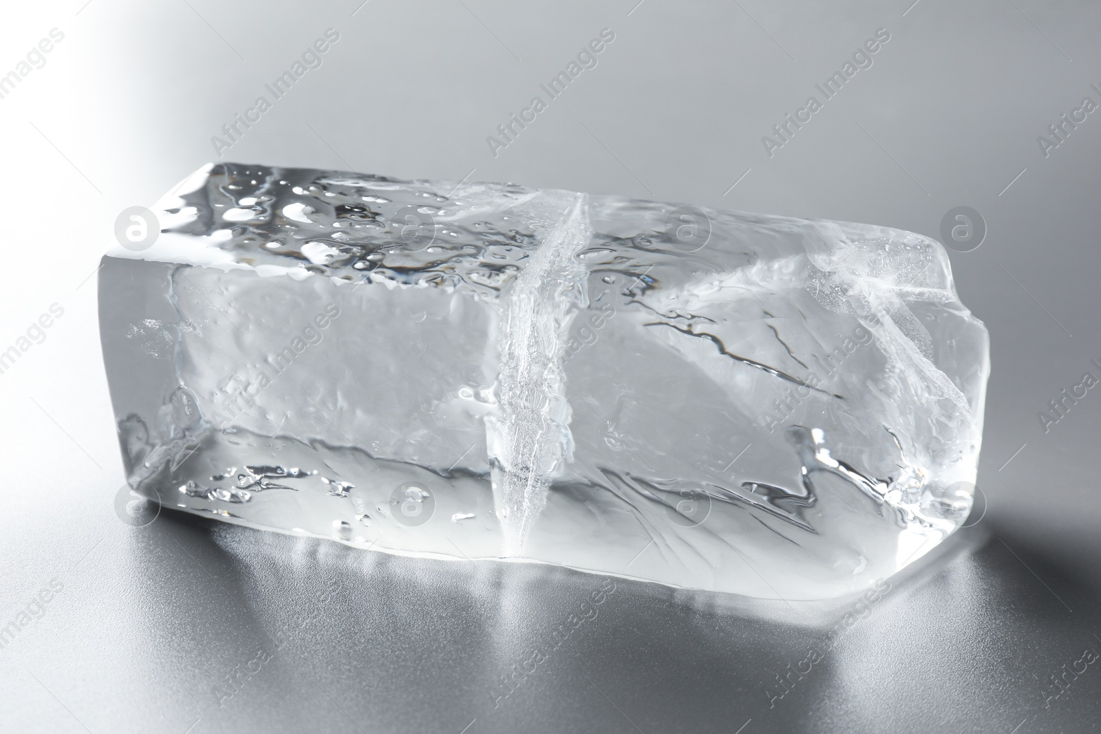 Photo of Piece of clear ice on light grey table