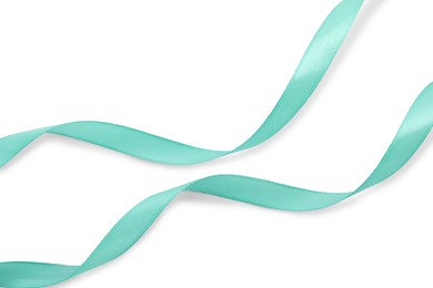 Photo of Beautiful turquoise ribbon isolated on white, top view
