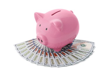 Photo of Pink piggy bank and money on white background