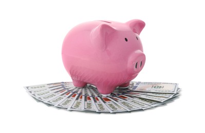 Pink piggy bank and money on white background