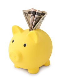 Photo of Yellow piggy bank with money on white background