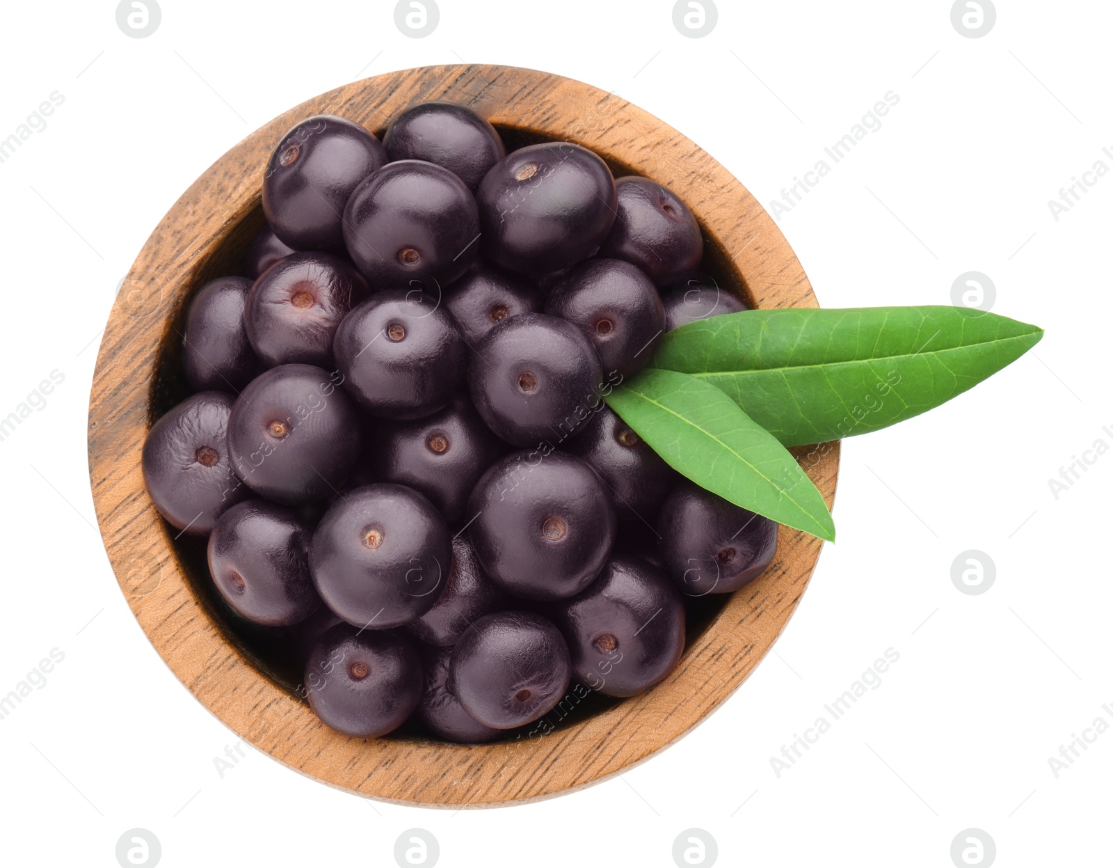 Photo of Fresh ripe acai berries in bowl and green leaves isolated on white, top view