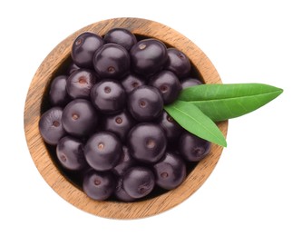 Photo of Fresh ripe acai berries in bowl and green leaves isolated on white, top view