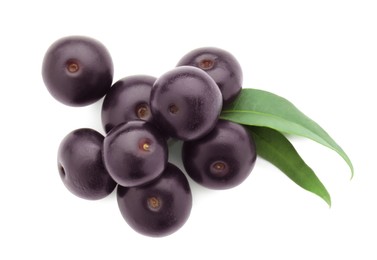 Fresh ripe acai berries and green leaves isolated on white, top view